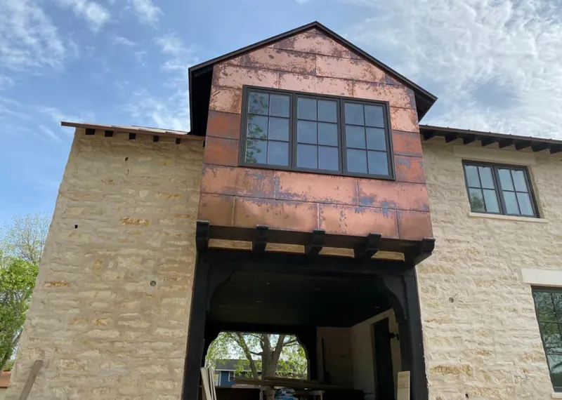 Copper metal panel facade on a stone building for Skylight Installation in Aloha