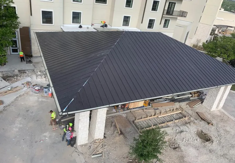 Metal roofing installation team working on a commercial building in Aloha